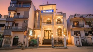 A multi-story hotel with a prominent 'TabHotels' sign, a grand entrance with steps, and a gated driveway. - Fabhotel Raj Palace (Lucknow)