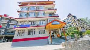 A multi-story hotel with a prominent entrance and a sign for 'Hotel Sourabh'. - Fabhotel Saurabh Inn (Manali)