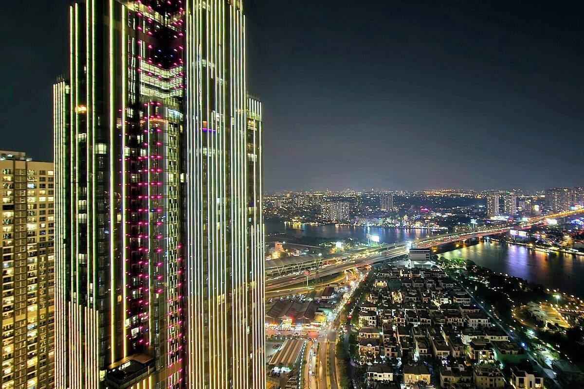 A high-rise building with a modern design, featuring vertical lines and a dense arrangement of windows.