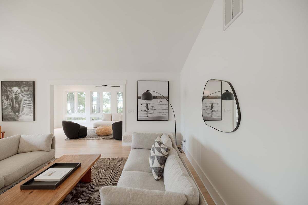 A modern living room with a sofa, coffee table, and artwork on the walls.
