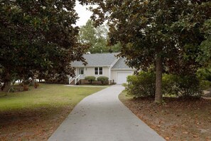 A residential house with a driveway leading to the garage. - Luxury Waterfront Cottage with Panoramic Waterway Views (Wilmington)
