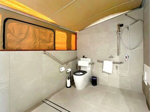 A modern bathroom with a toilet, bidet, and shower. - Magnetic Glamping (Nelly Bay)