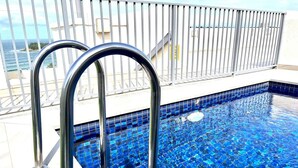 A swimming pool with blue mosaic tiles and metal railings. - Beachfront Living, Manly Beach, Sydney (Manly)