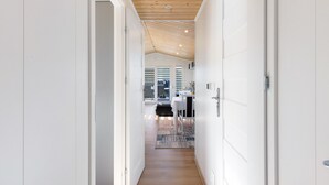 A hallway with wooden flooring, white walls, and a sloped ceiling. - Holiday Home 'Madera Concordiasee' with Wi-Fi and Air Conditioning (Seeland)