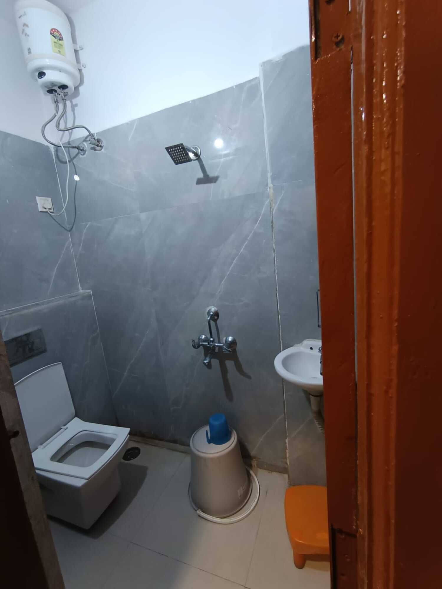 A small bathroom with a toilet, bidet, and sink.