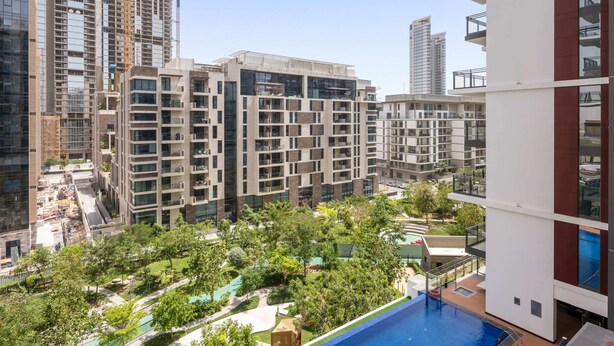 A modern residential building with multiple balconies, a rooftop pool, and surrounding greenery. - Wilton Park Res - Nad Al Sheba (Dubai)