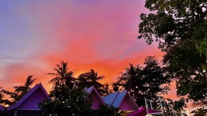 A resort with colorful buildings and a pink slide. - Slumber Party Beach Koh Phangan (Ko Pha-ngan)