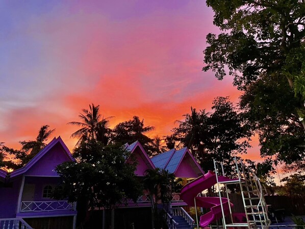A resort with colorful buildings and a pink slide. - Slumber Party Beach Koh Phangan (Ko Pha-ngan)