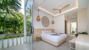 A modern bedroom with a large bed, ceiling fan, and potted plants. - Modern Open Design 4BR Pool Villa Mina (Rawai)