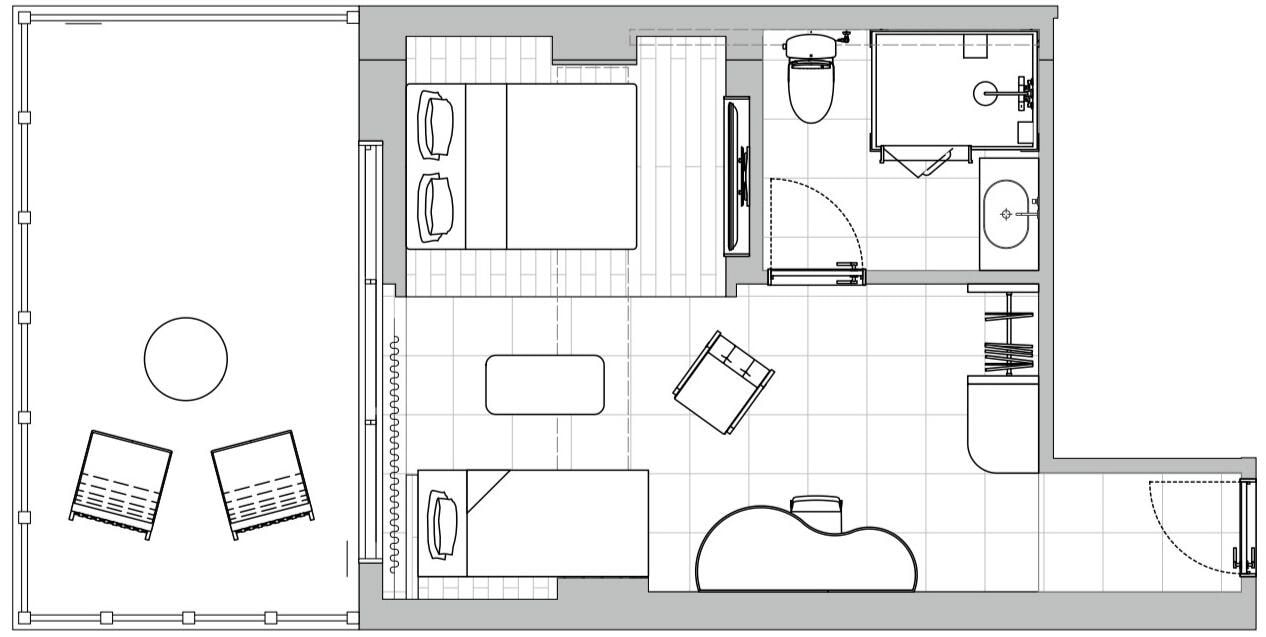 A floor plan of a hotel room with a bed, a desk, a bathroom, and a living area.