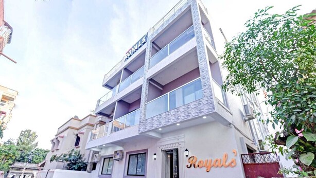 A multi-story building with balconies and a sign that reads "Royals".