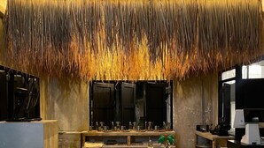 A modern kitchen with a central island, a bar area, and a decorative ceiling. - Waste Land Homestay & Resort Chiangmai (San Pa Thong)