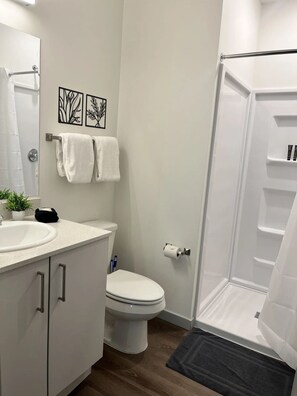 A modern bathroom with a toilet, sink, and shower. - Stay on M Street (Lincoln)