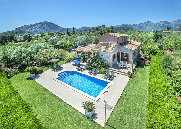 A house with a swimming pool, outdoor furniture, and a well-maintained garden. - VILLA ROSTOYA - 10 MIN WALK TO THE OLD TOWN (Pollensa)