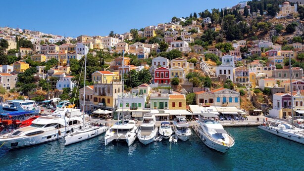 A coastal town with colorful buildings and a marina with yachts. - House in Symi with sea view (Simi)