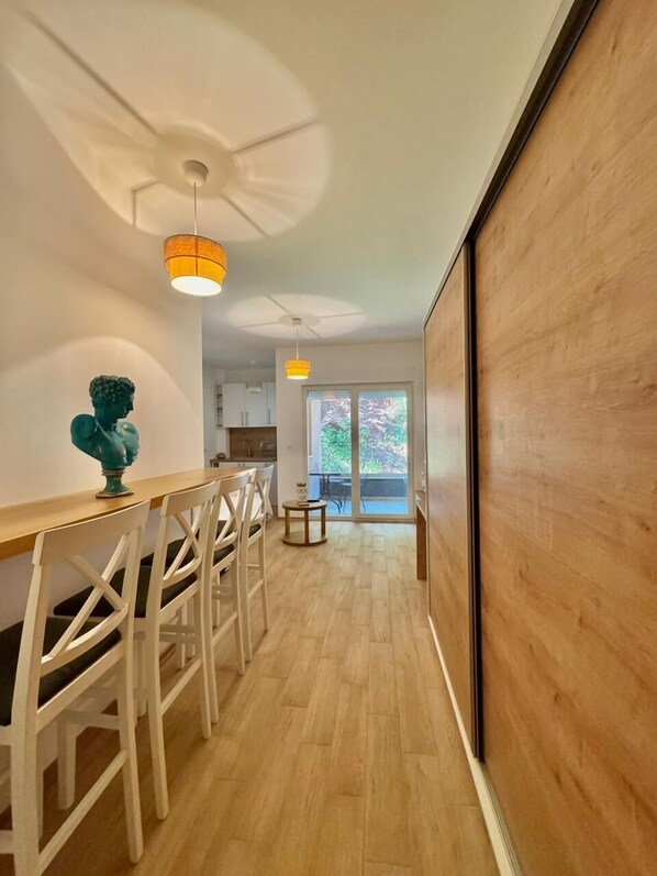 A modern kitchen with white cabinets and a wooden countertop. - Couple Studio Angela (Budva)