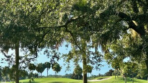 A golf course with sand bunkers, water hazards, and a clear sky. - Beautiful Bungalow - 3/2 w/ Golf Cart in The Village of Liberty Park SMALL DOG Accepted - Max 1x 20-25lbs (The Villages)