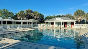 A swimming pool with lounge chairs and a covered pavilion. - Beautiful Bungalow - 3/2 w/ Golf Cart in The Village of Liberty Park SMALL DOG Accepted - Max 1x 20-25lbs (The Villages)