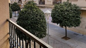 A multi-story residential building with balconies and a paved ground floor. - Charming Apartment with Pool & Garage in Córdoba's Prime Shopping District (Córdoba)