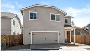 A two-story residential building with a garage, a wooden fence, and a driveway. - Windtree Hideaway! Trees, hiking, minutes downtown (Flagstaff)