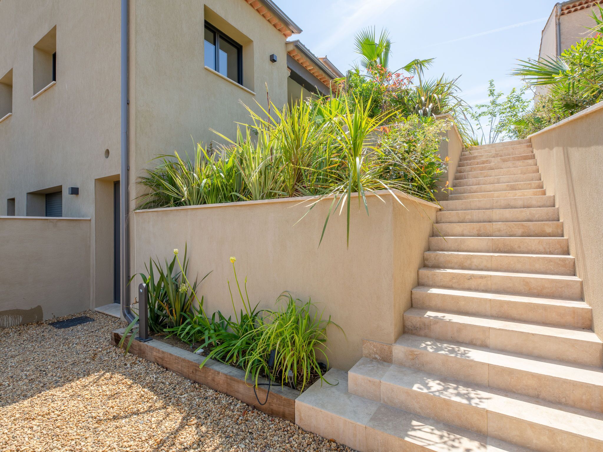 A modern building with a stone staircase leading to an upper level.