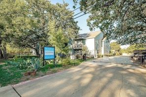 A gated residential complex with a sign indicating furnished condos for lease. - I48-1 - Apt|Patio|11mi to Convention Ctr|Sleeps 2 (Irving)