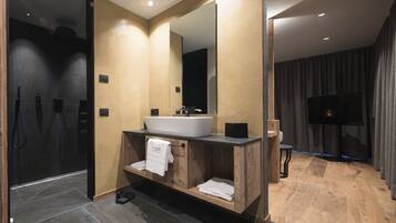 Un baño moderno con un espejo grande, tocador de madera y una bañera.