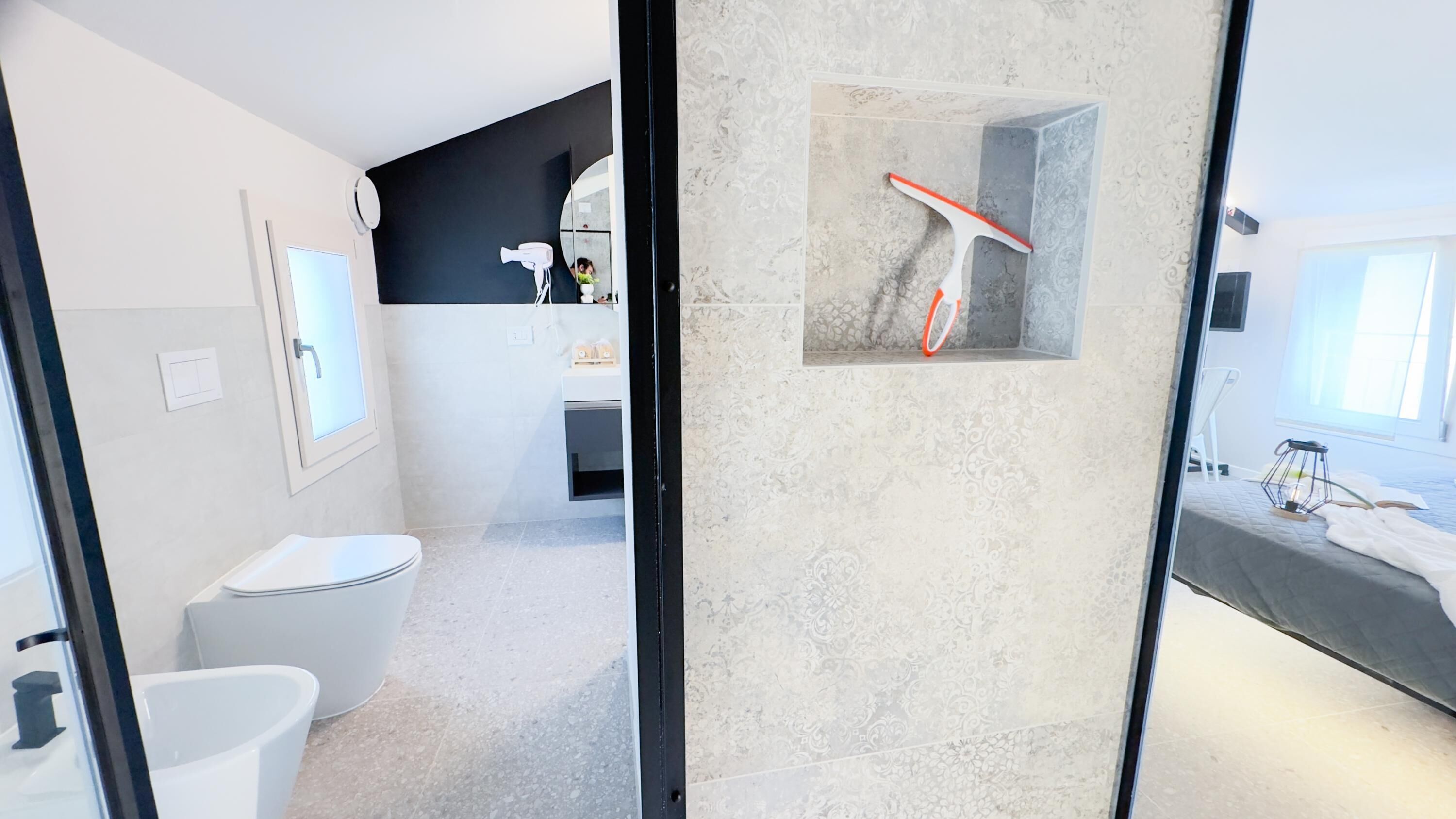 A modern bathroom with a toilet, sink, and shower area.
