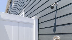 A white fence, a grey exterior wall, and a metal door handle. - Spacious 3BR Condo Near Ventnor Beach (Ventnor City)