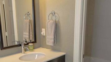 Shower, hair dryer, towels, shampoo