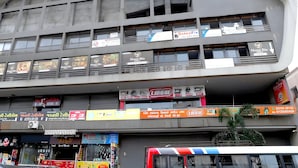 A multi-story building with various commercial establishments on the ground floor, including a hotel named 'Hotel Rio'. - Hotel Rio Orbit (Rajkot)