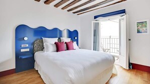 A bedroom with a blue headboard, white bedding, and a wooden ceiling. - A Glorious 2-Ch/2SdB w/ Services in Saint-Germain (Paris)
