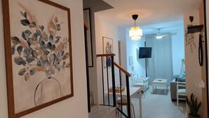 A modern interior with a staircase, a dining area, and a living space. - Amazing & Renovated 2-bedroom Flat in Fuengirola (Fuengirola)