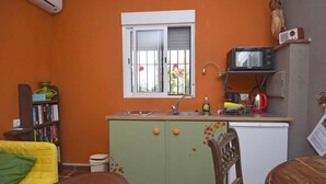 A compact kitchen with a window, a microwave, and a sink. - Fantastic View and Lovely Atmosphere Casita Adelfa (Alhaurin de la Torre)