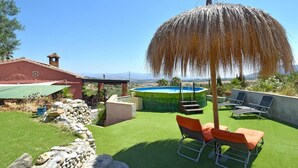 A backyard with a swimming pool, outdoor seating, and a view of the countryside. - Fantastic View and Lovely Atmosphere Casita Adelfa (Alhaurin de la Torre)