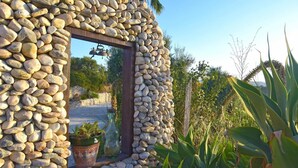 A stone wall with a window and potted plants. - Fantastic View and Lovely Atmosphere Casita Adelfa (Alhaurin de la Torre)