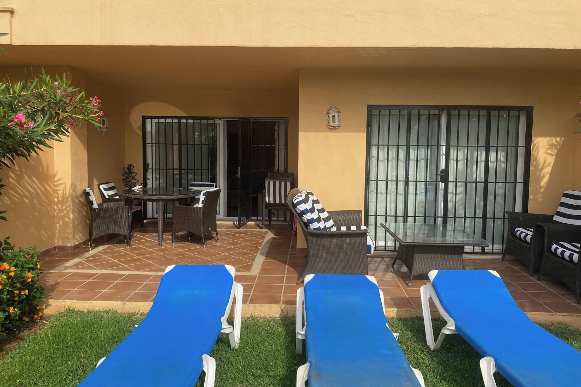 Un patio con dos sillones de descanso, una mesa y sillas.