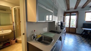 A modern kitchen with a sink, countertop, and cabinets.