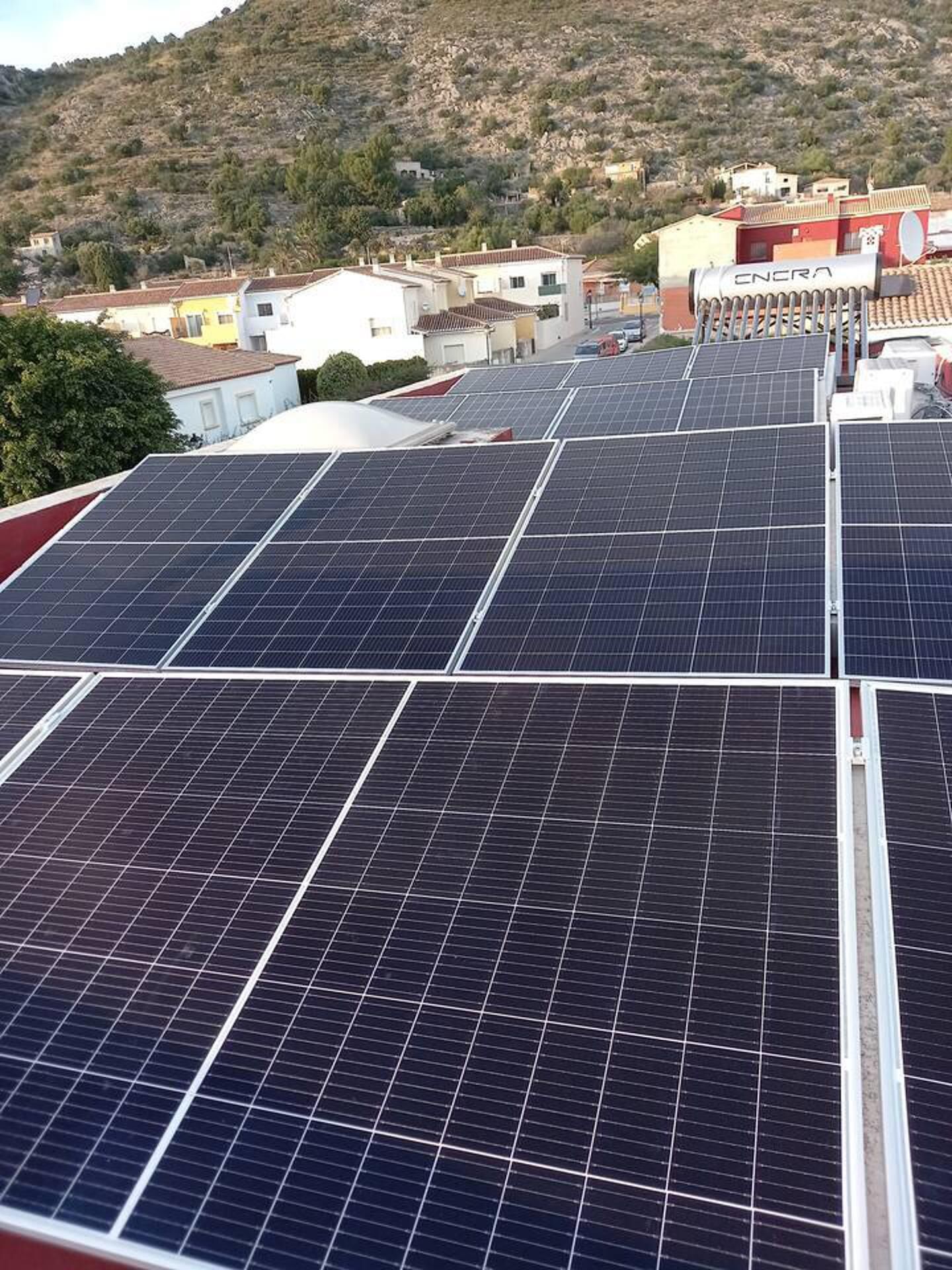 Solar panels on a building's roof in a residential area.