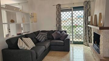 Villa | Living area | TV, fireplace