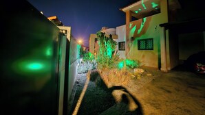 A narrow street with buildings on either side, a cactus in the center, and a car parked on the right. - Private Pool- Rooftop Terrace & Bbq- Aircon (Zurgena)