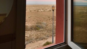 A room with a window overlooking a desert landscape at sunset. - Relaxing and Welcoming Villa, Corralejo, Canaries (La Oliva)