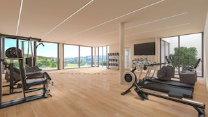 A modern gym with exercise equipment, large windows, and a view of the countryside. - Stunning Apartment Close to Golf, Mijas, Spain (Mijas)