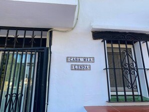 A white building with two windows, each with black metal bars. There are two signs on the wall: 'CASA MIA' and 'LINDA'. - Calahonda - Sleeps 6 - Parking - Garden - Pool (Mijas)
