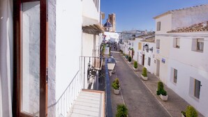 A narrow street with white buildings, a bell tower, and a staircase leading to a balcony. - Sea View-2 Bed-sleeps 5-balcony-private Parking (Altea)