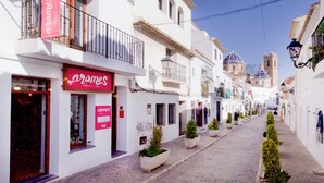 A narrow street lined with white buildings, some with balconies and small planters. - Sea View-2 Bed-sleeps 5-balcony-private Parking (Altea)