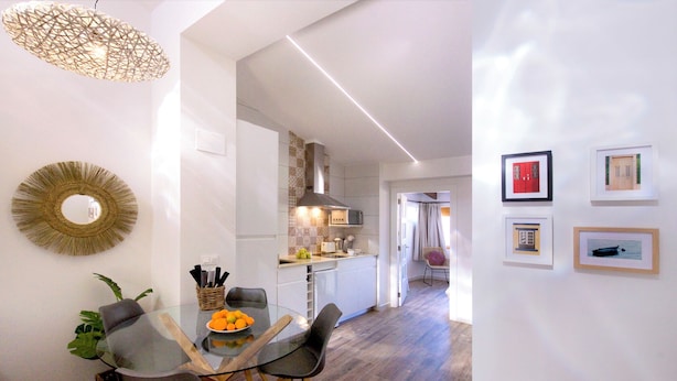 A modern kitchen with white cabinets, a microwave, and a hanging light fixture. - Sea View-2 Bed-sleeps 5-balcony-private Parking (Altea)
