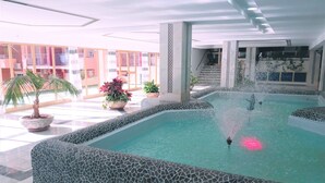 A swimming pool with a fountain, surrounded by tiled walls and potted plants. - Minerva 1-bedroom, Close to the Beach, Park etc (Benalmádena)