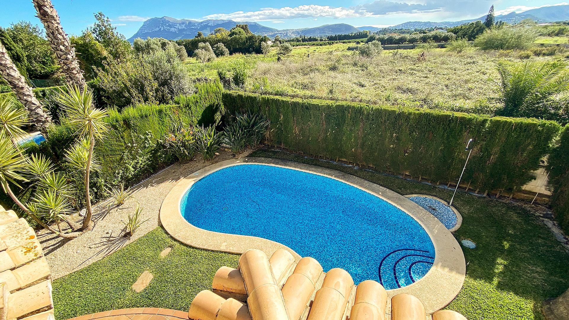 A swimming pool with a view of mountains in the background.
