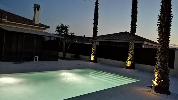A swimming pool surrounded by palm trees and a house with a tiled roof. - Villa - Sleeps 4 - Pool - Patio - Parking (Arboleas)